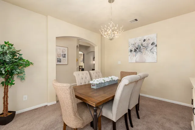 a view of a dining room with furniture and chandelier