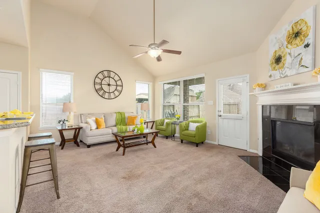 a living room with fireplace furniture and a window