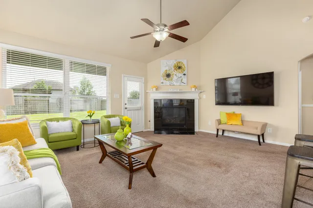 a living room with furniture fireplace and a flat screen tv
