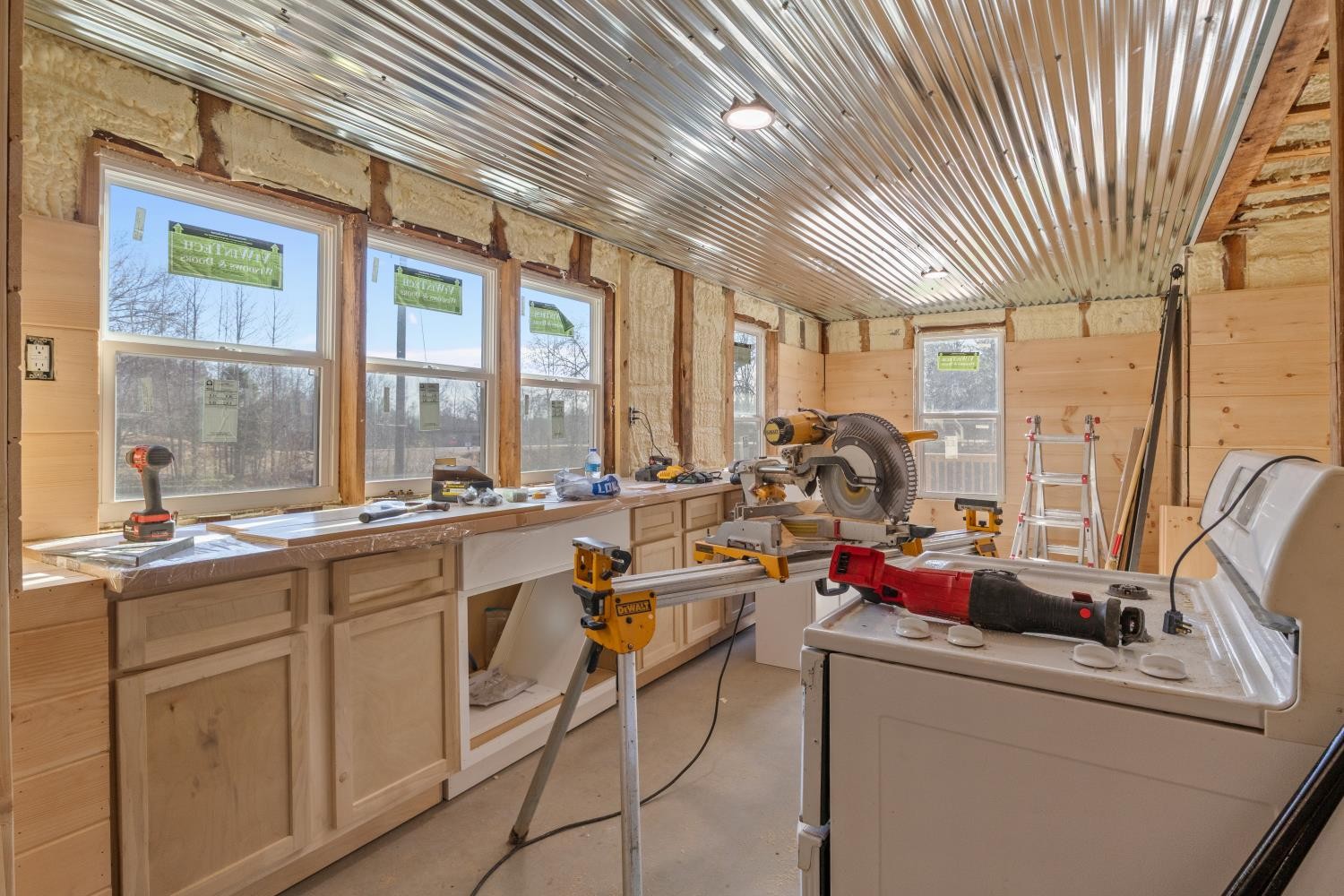 70 Old Bruceton Road Bruceton, TN 38317 - Photo 18 of 33 a view of a kitchen with kitchen island granite countertop a large window a sink and cabinets