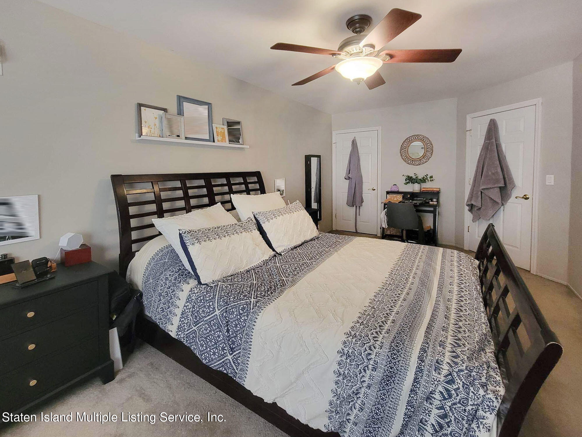 1040 Rathbun Avenue, Unit C Staten Island, NY 10309 - Photo 11 of 17 a bedroom with a bed and a chandelier