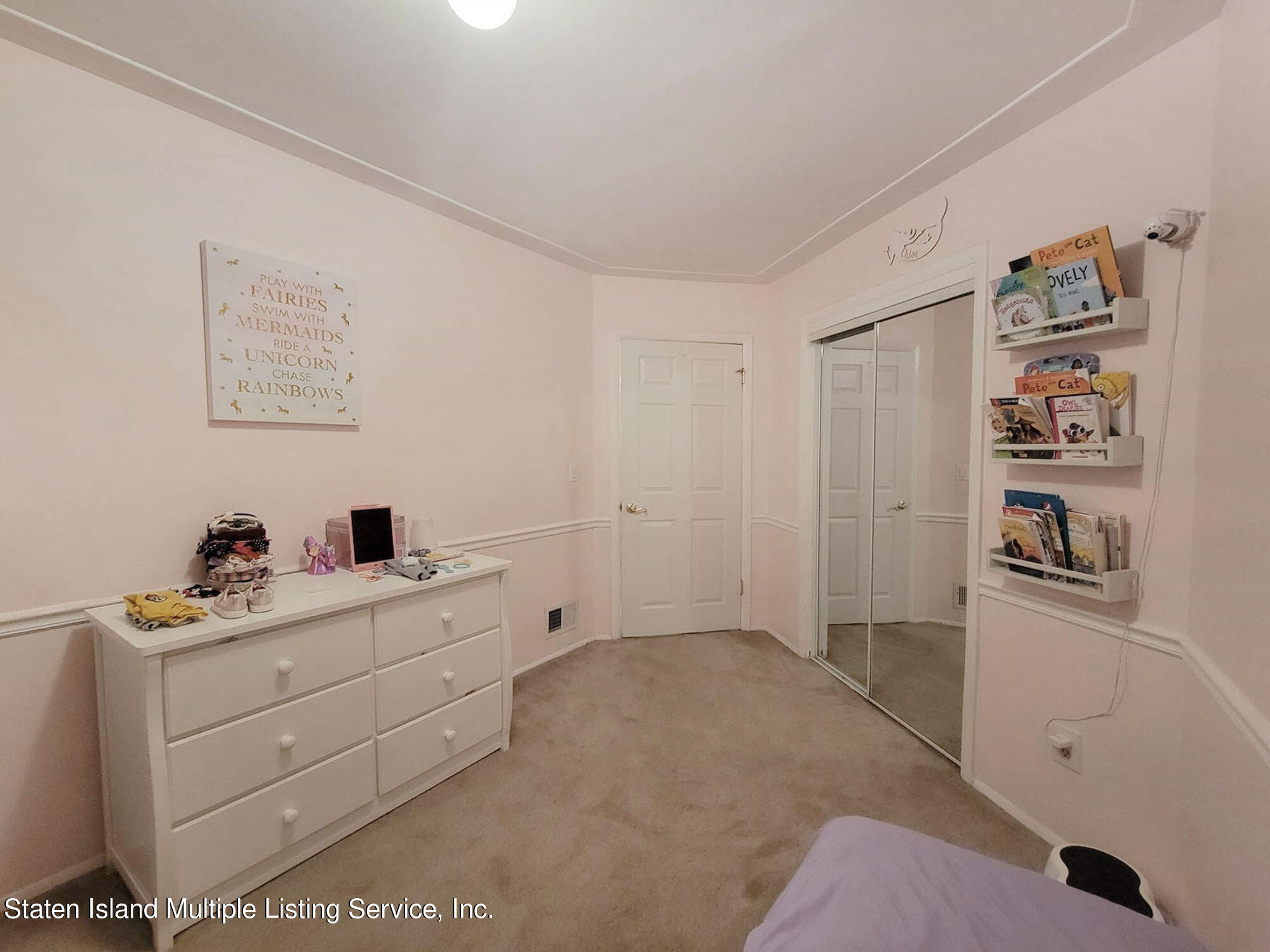 1040 Rathbun Avenue, Unit C Staten Island, NY 10309 - Photo 14 of 17 a room with a baby crib and a dresser