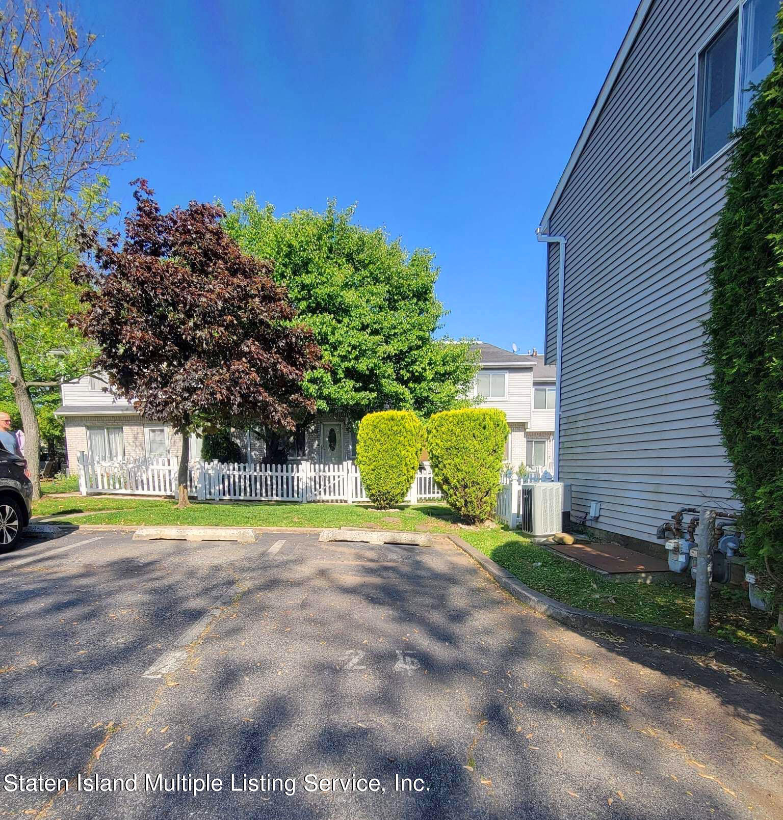 1040 Rathbun Avenue, Unit C Staten Island, NY 10309 - Photo 16 of 17 a view of a house with a yard and a garage