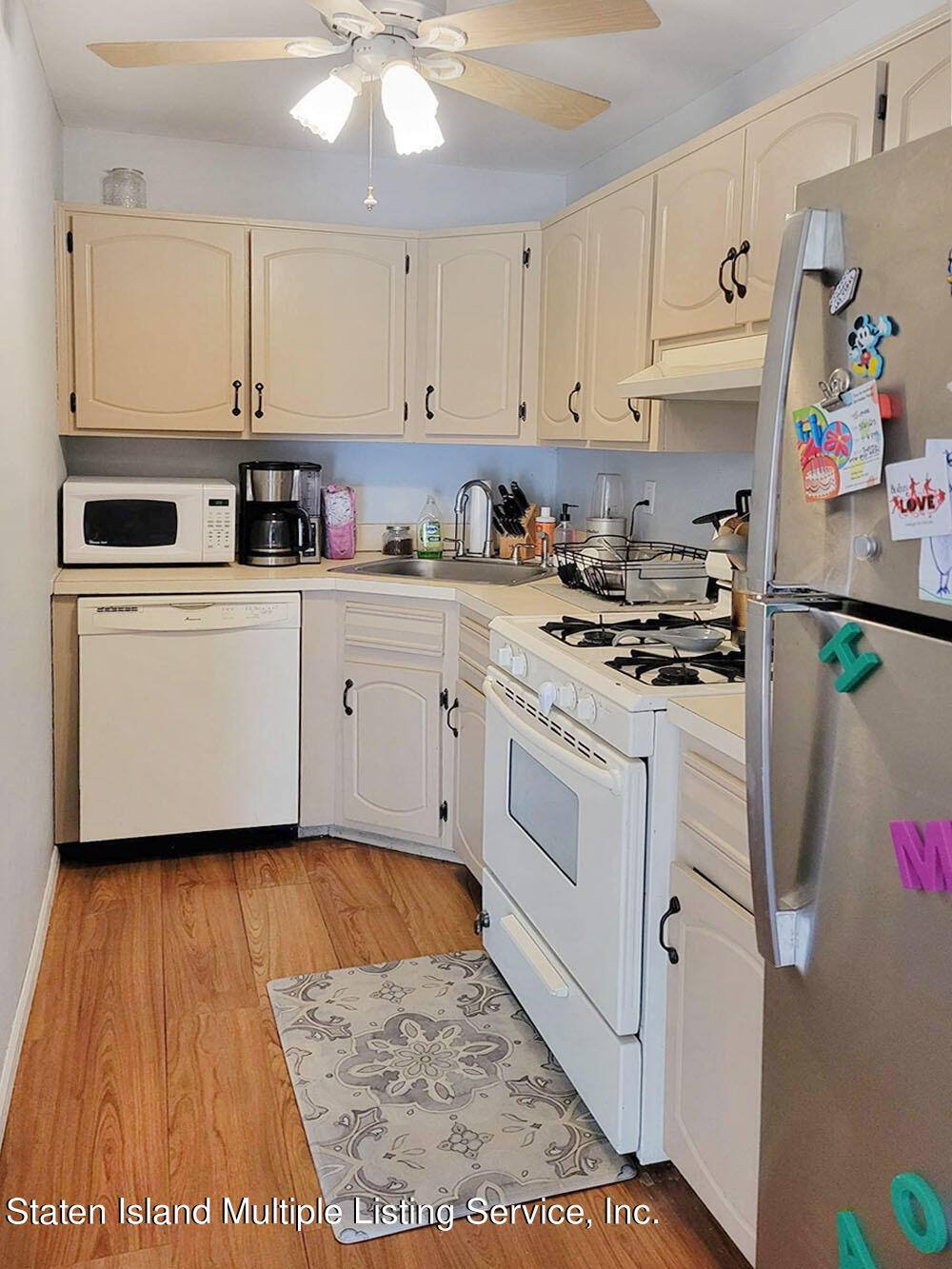1040 Rathbun Avenue, Unit C Staten Island, NY 10309 - Photo 8 of 17 a kitchen with white cabinets and white appliances