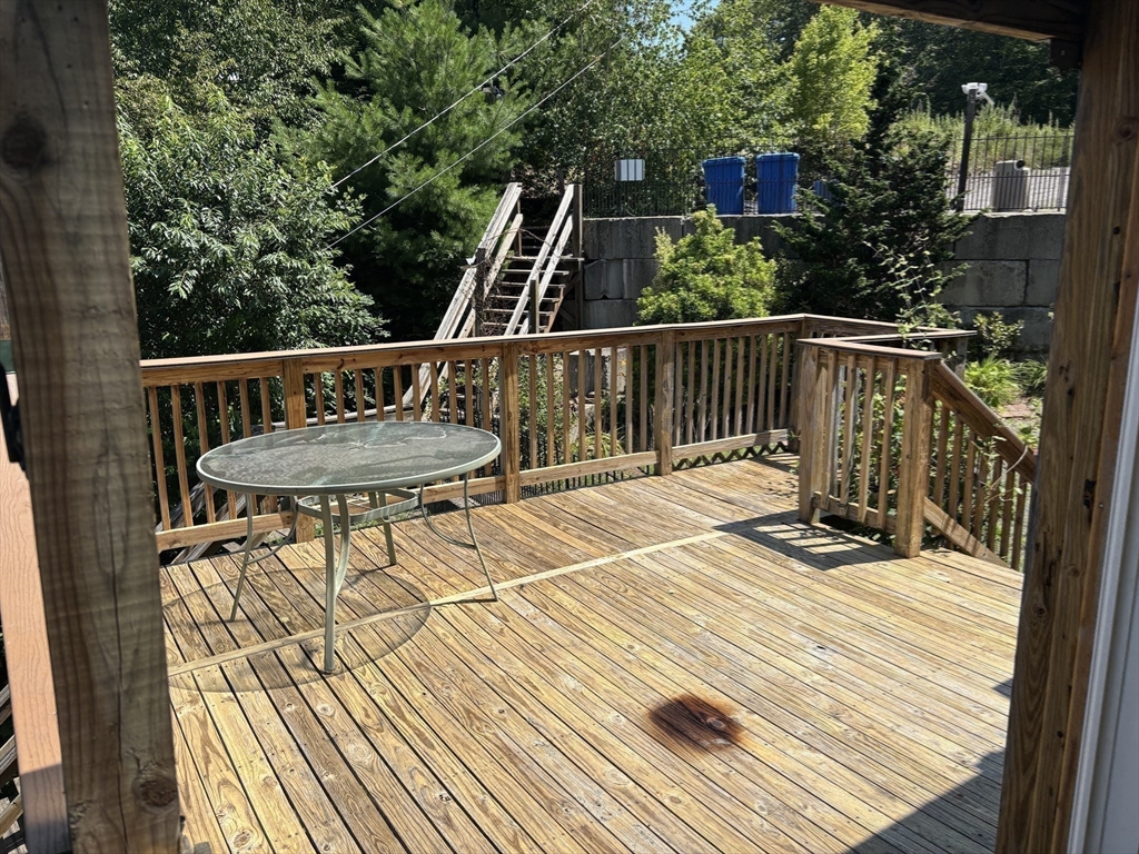 570 Eastside Road Wrentham, MA 02093 - Photo 23 of 31 a view of balcony with wooden floor and outdoor seating