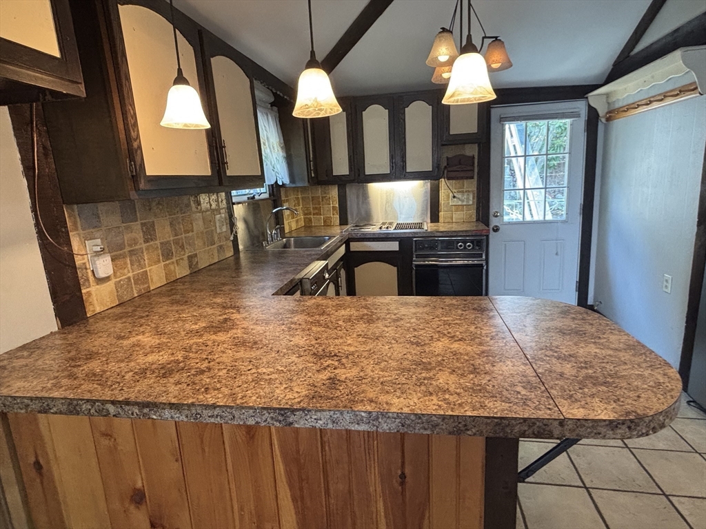 570 Eastside Road Wrentham, MA 02093 - Photo 4 of 31 a kitchen with a stove and a sink