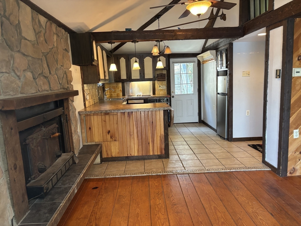 570 Eastside Road Wrentham, MA 02093 - Photo 7 of 31 a view of a livingroom with wooden floor and a fireplace