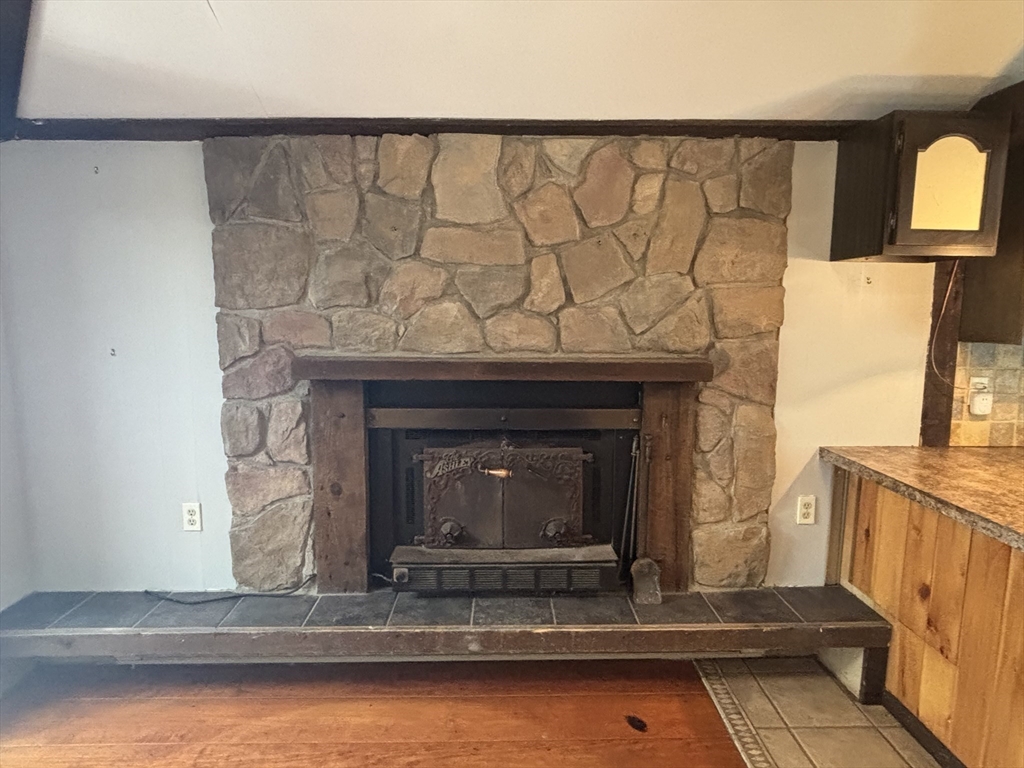 570 Eastside Road Wrentham, MA 02093 - Photo 8 of 31 a fireplace with a clock on wall