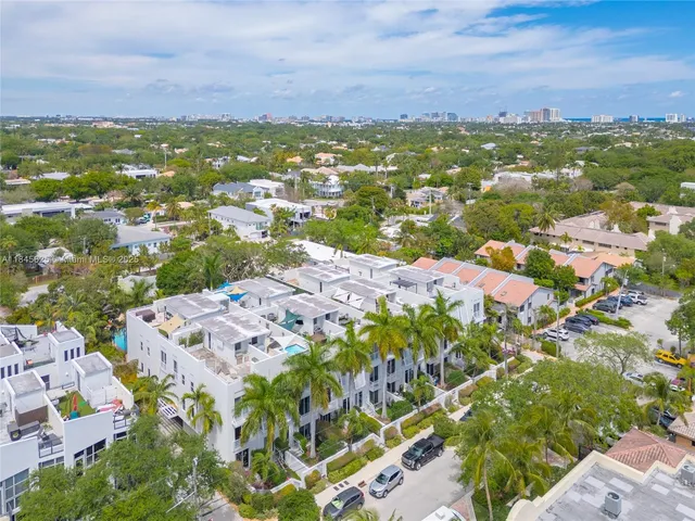 an aerial view of residential houses with outdoor space