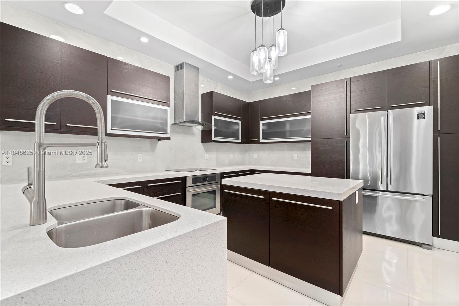 811 Southeast 12th Court Fort Lauderdale, FL 33316 - Photo 4 of 18 a kitchen with stainless steel appliances granite countertop a refrigerator a stove and a sink with wooden floor