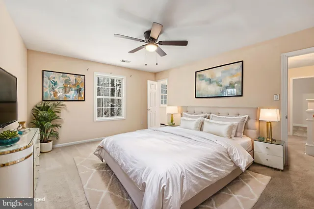 a bedroom with a large bed and a chandelier