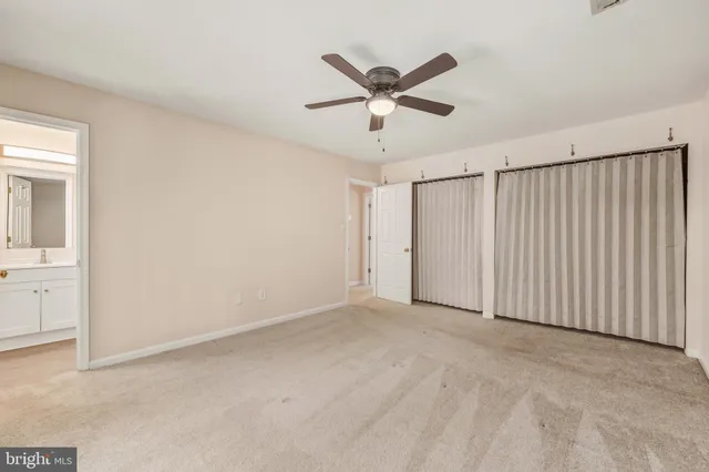 a view of a livingroom with a ceiling fan and entryway