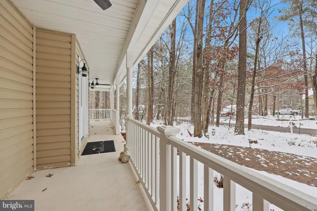 a view of a porch with wooden fence and floor