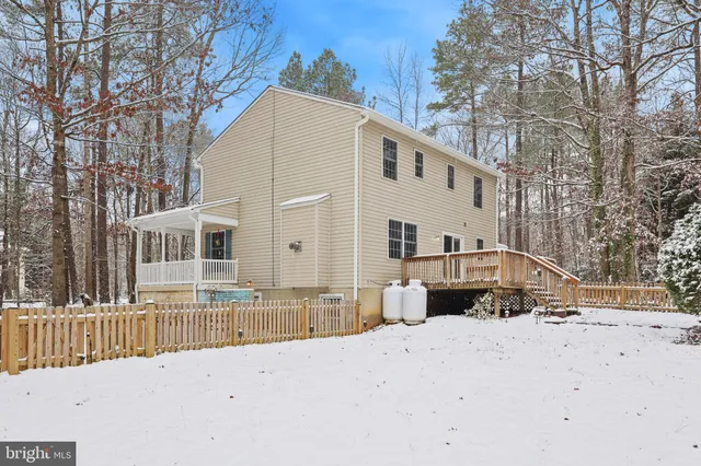 a view of a house with a yard covered in snow