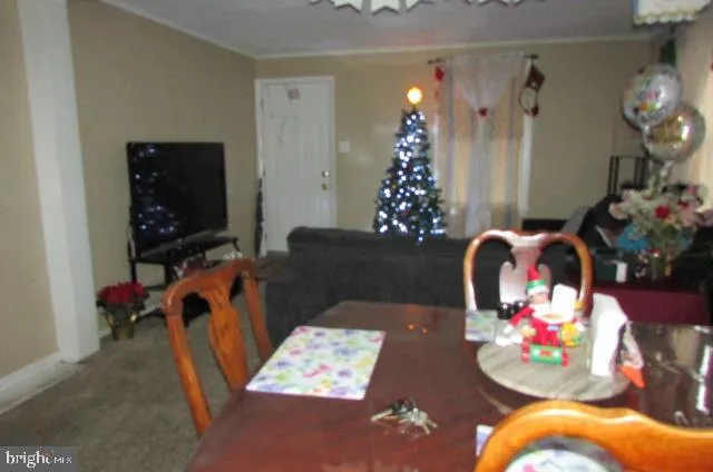a living room with furniture and flowers