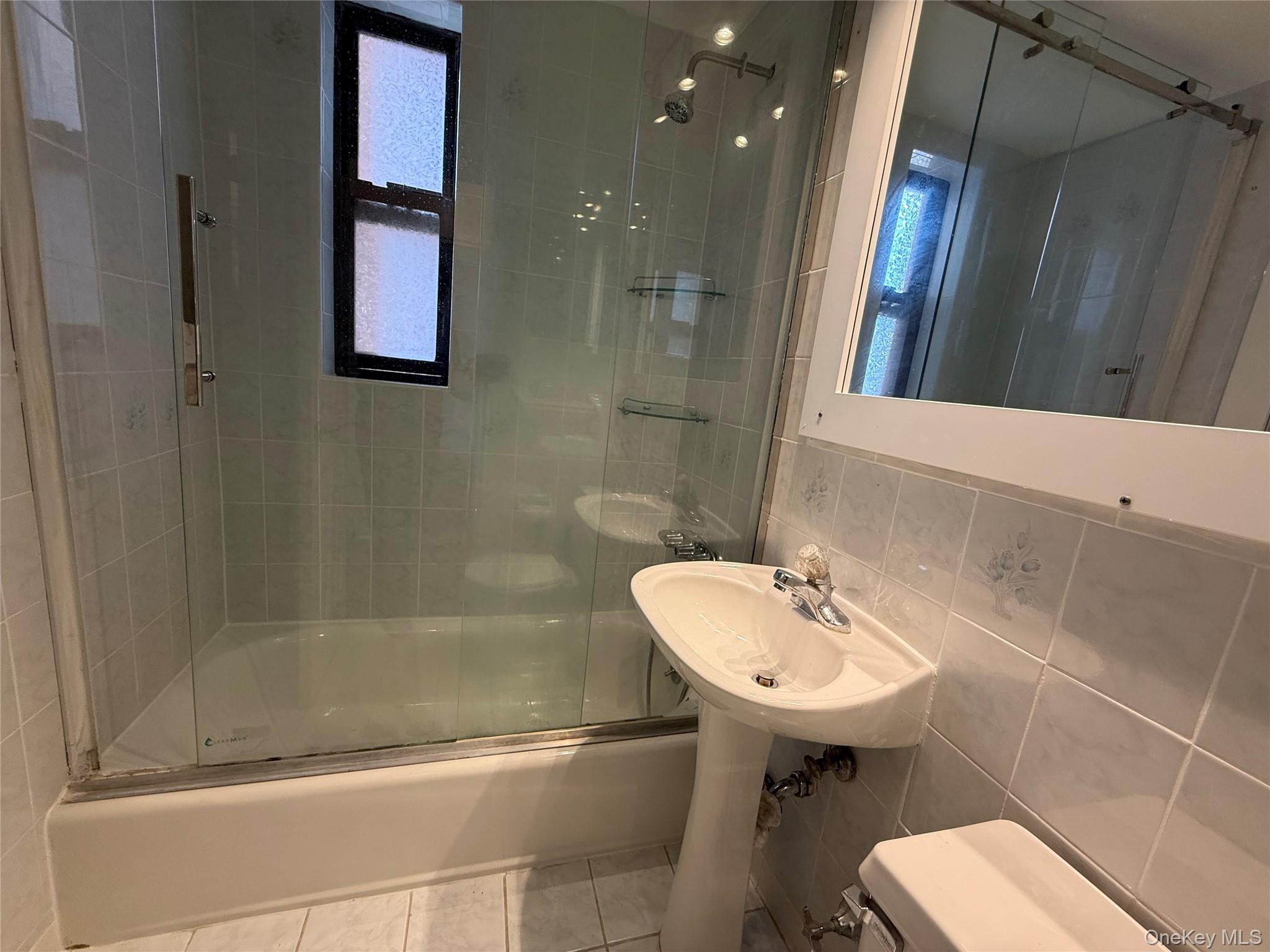 142 Garth Road, Unit 1P Scarsdale, NY 10583 - Photo 19 of 22 a bathroom with a sink a toilet and shower