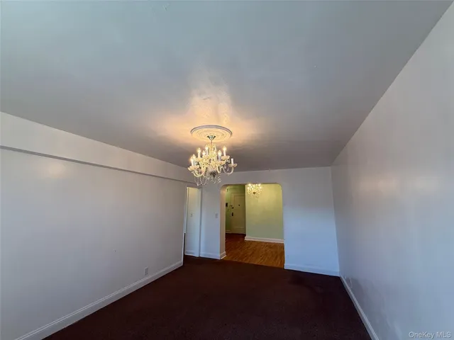 a kitchen with granite countertop a refrigerator and a stove top oven
