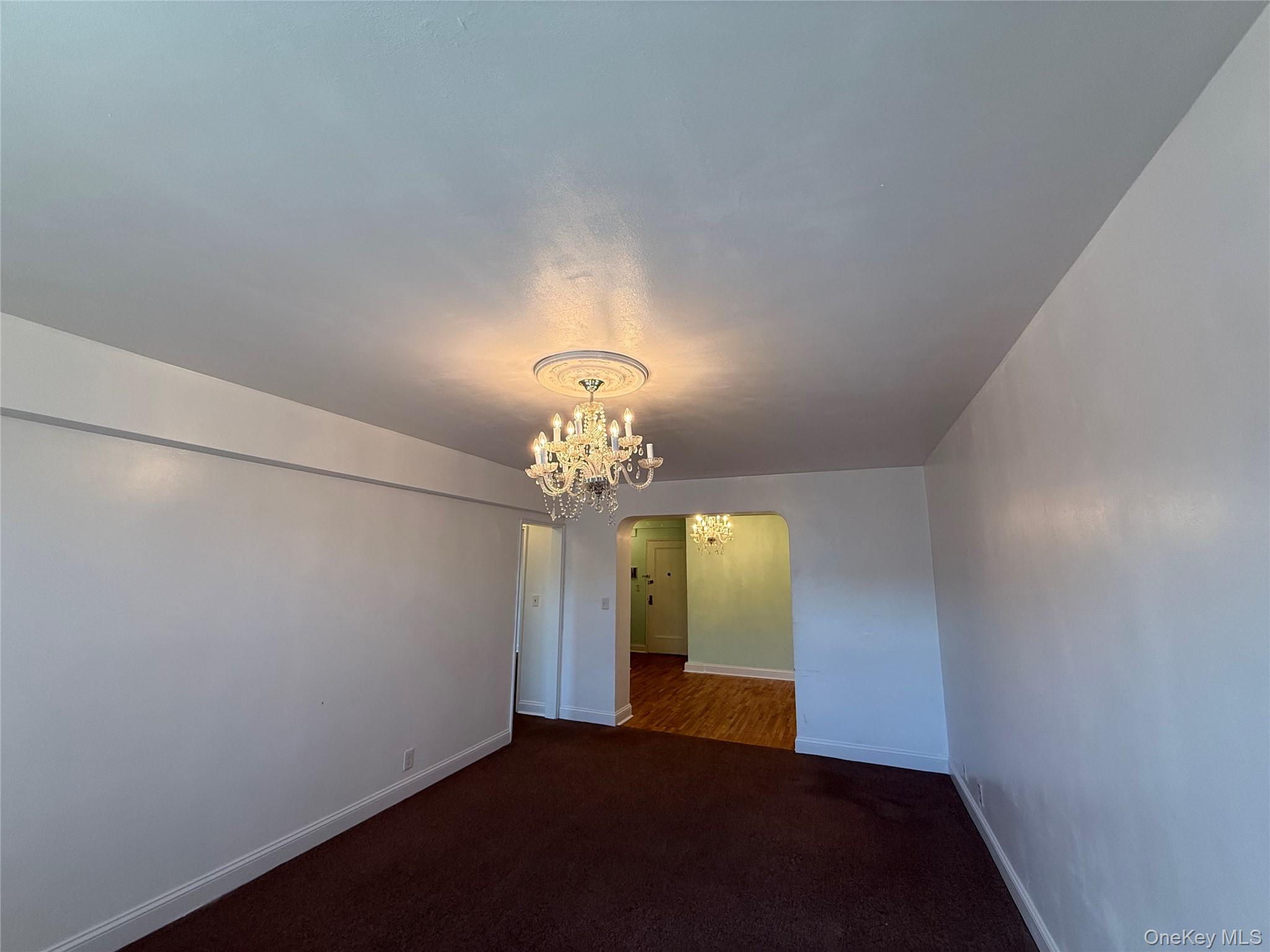 142 Garth Road, Unit 1P Scarsdale, NY 10583 - Photo 20 of 22 a view of a livingroom with a chandelier