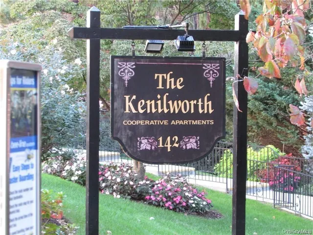 a sign broad in front of red brick house