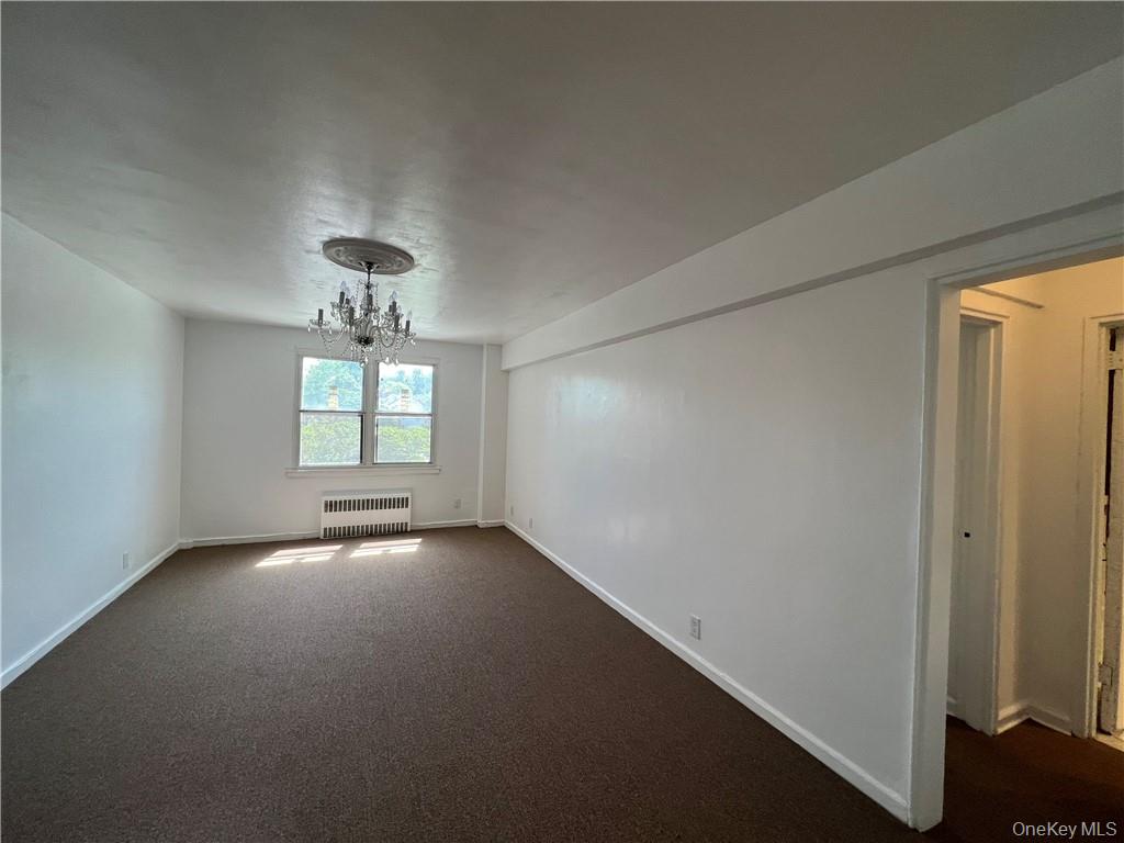142 Garth Road, Unit 1P Scarsdale, NY 10583 - Photo 8 of 22 a view of an empty room with a window