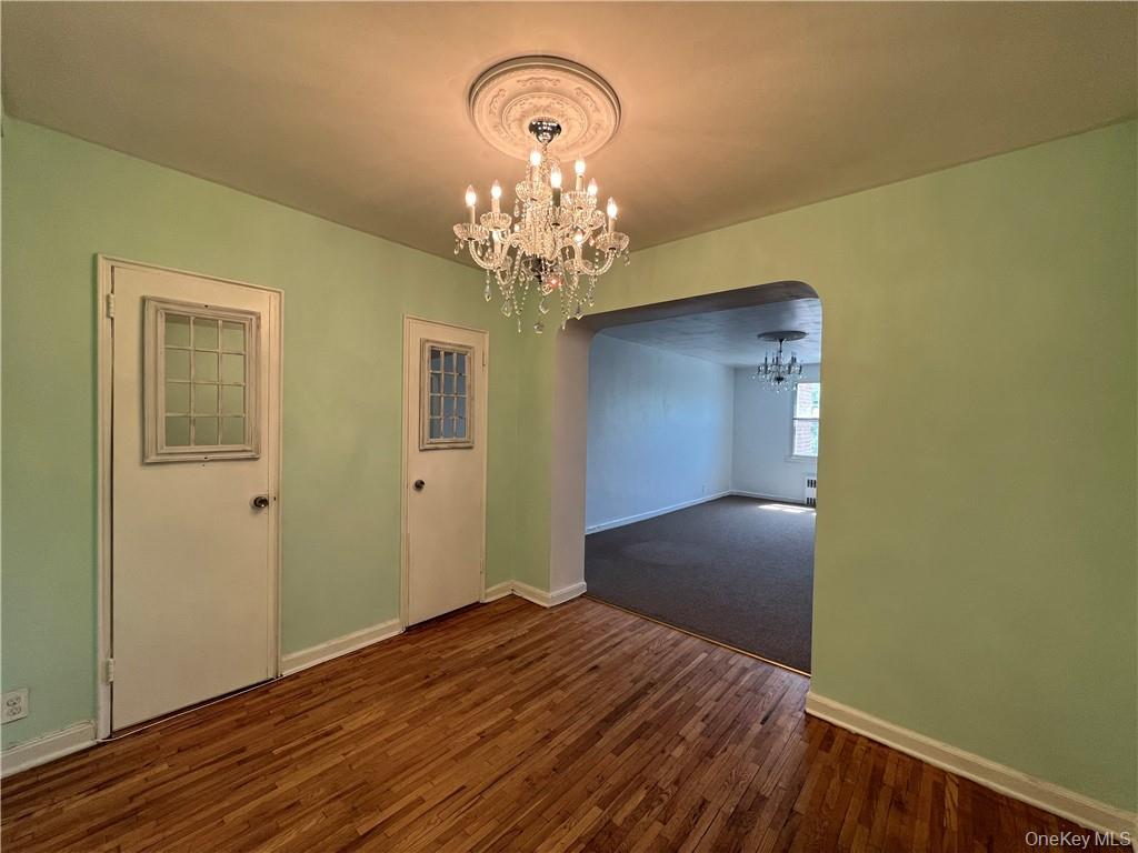 142 Garth Road, Unit 1P Scarsdale, NY 10583 - Photo 9 of 22 a view of a livingroom with wooden floor