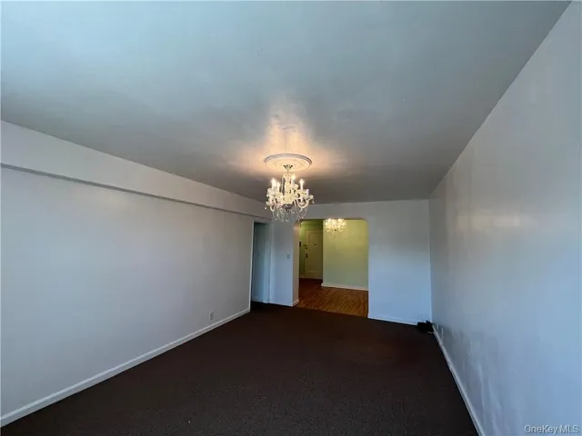 a view of a chandelier fan and entryway
