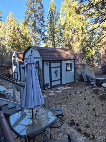 a front view of a house with a yard fire pit and wooden fence