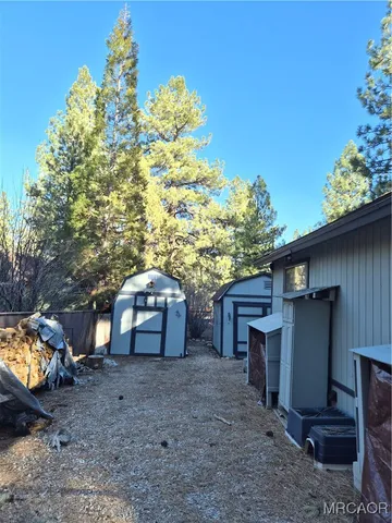 a view of a wooden door and a yard