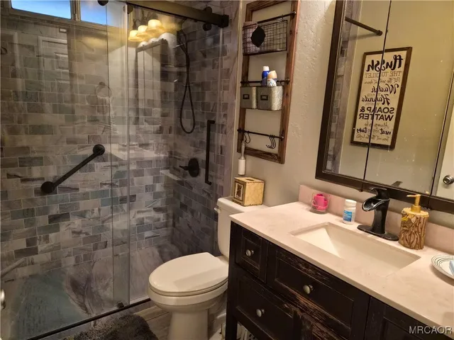 a bathroom with a sink toilet and shower