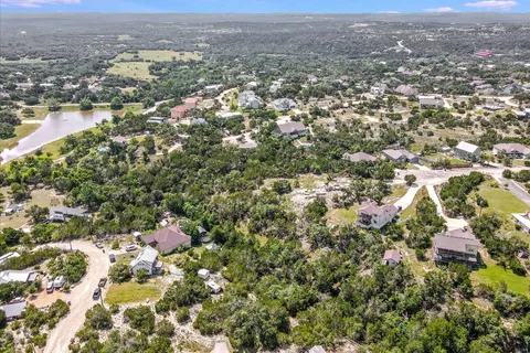 an aerial view of house with yard and mountain view in back