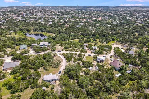 an aerial view of residential houses with city and outdoor space