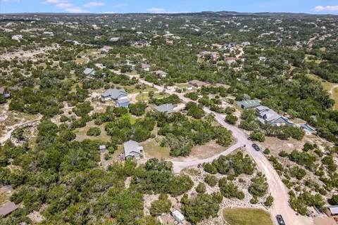 an aerial view of residential houses with city view