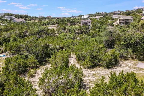 a view of a city with lush green forest