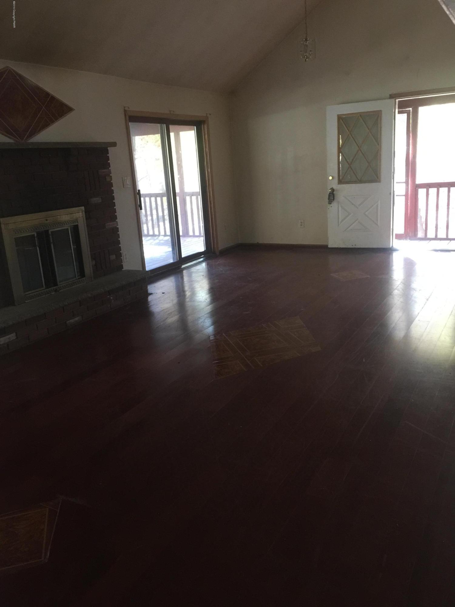 6220 Decker Road Bushkill, PA 18324 - Photo 4 of 13 a view of an empty room with wooden floor and a window
