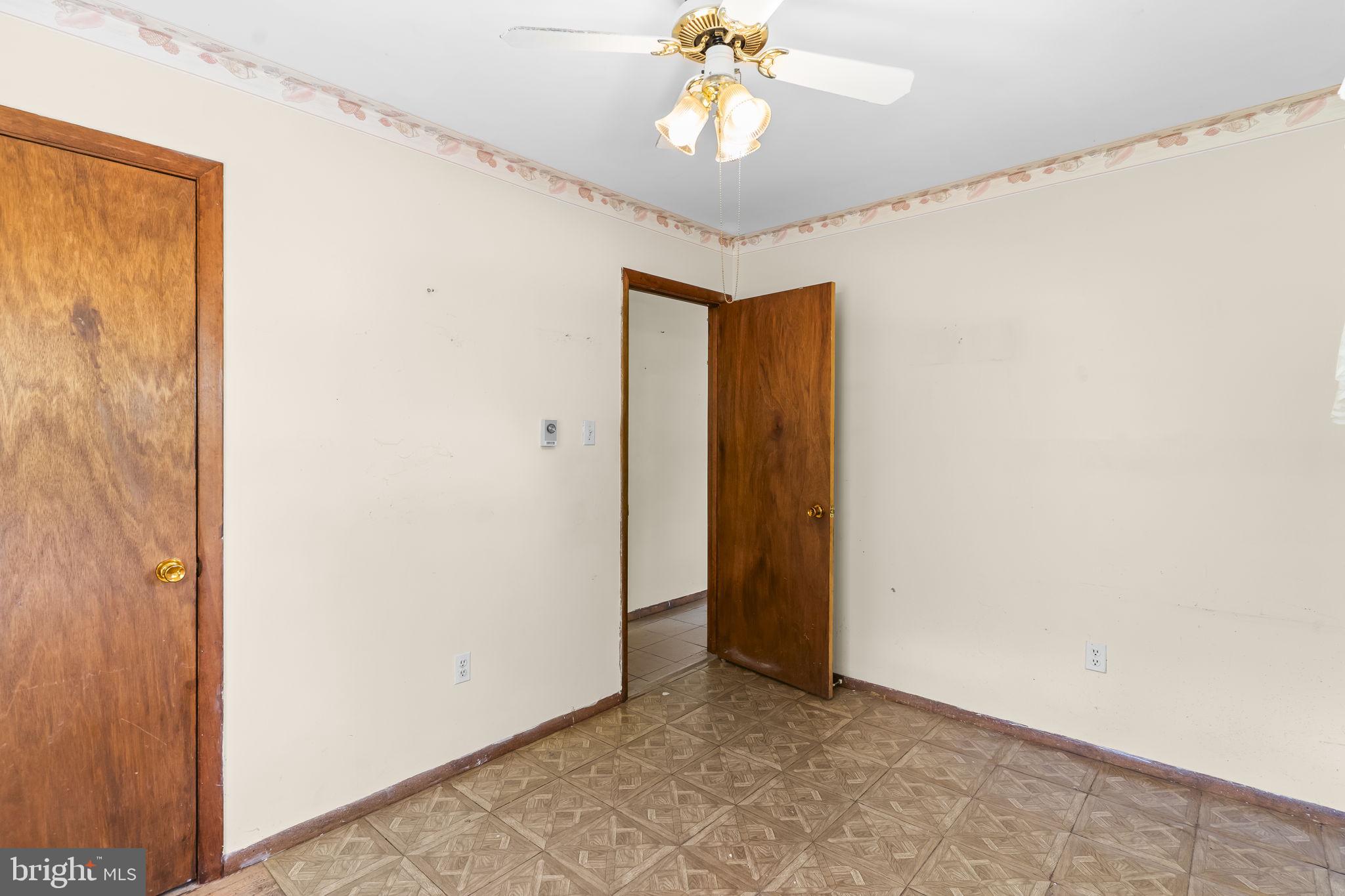 36031 Bay Drive Chaptico, MD 20621 - Photo 22 of 34 an empty room with a chandelier fan and closet