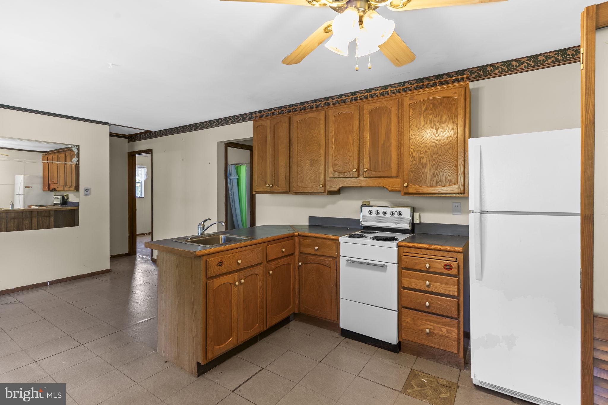 36031 Bay Drive Chaptico, MD 20621 - Photo 3 of 34 a kitchen with stainless steel appliances granite countertop a stove a refrigerator and a stove top oven