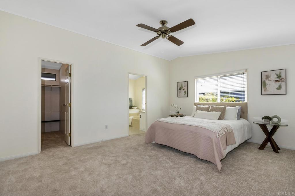 5212 Weymouth Way Oceanside, CA 92057 - Photo 15 of 39 a bedroom with a bed and a chandelier