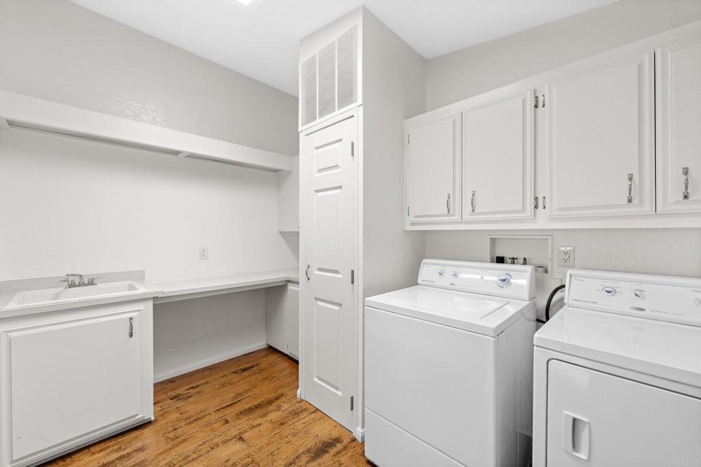 5212 Weymouth Way Oceanside, CA 92057 - Photo 30 of 39 a view of washer and dryer with kitchen in the background