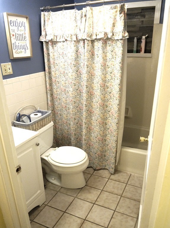 7 Pryor Road Natick, MA 01760 - Photo 16 of 24 a bathroom with a toilet and a shower curtain