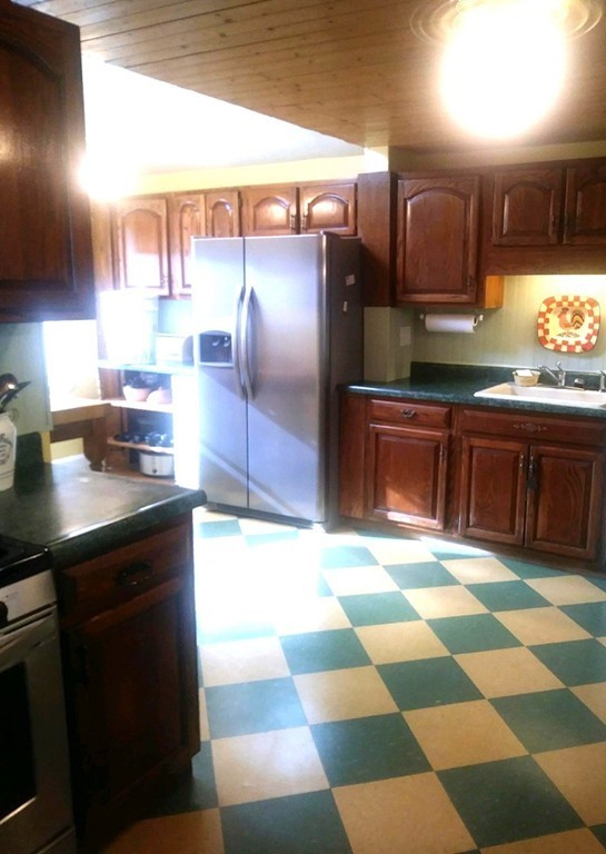 7 Pryor Road Natick, MA 01760 - Photo 5 of 24 a kitchen with stainless steel appliances granite countertop a sink and cabinets
