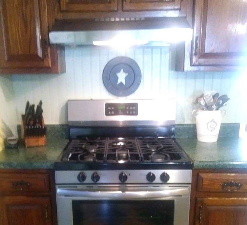 7 Pryor Road Natick, MA 01760 - Photo 7 of 24 a stove top oven sitting inside of a kitchen