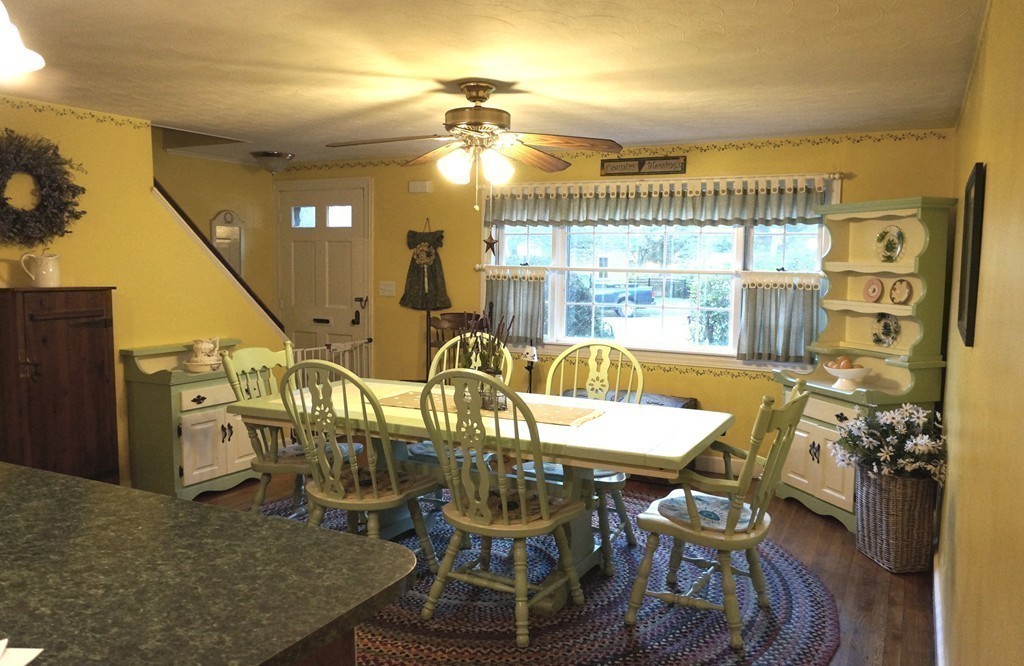7 Pryor Road Natick, MA 01760 - Photo 8 of 24 a view of a dining room with furniture a chandelier and large windows