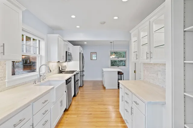 a large white kitchen with a large window