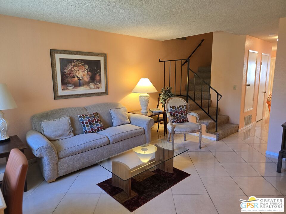 a living room with furniture and a lamp