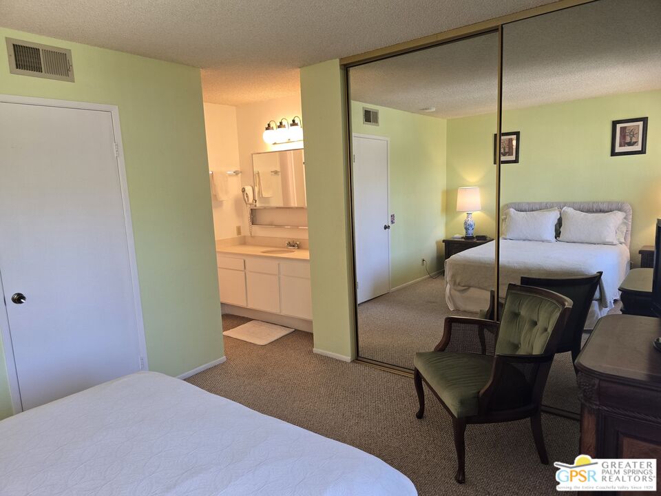 365 West Mariscal Road Palm Springs, CA 92262 - Photo 14 of 25 a bedroom with a bed and a chandelier