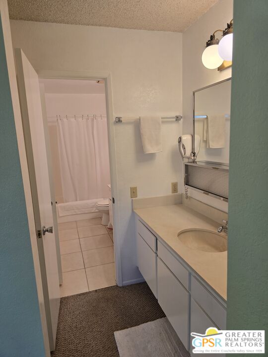 365 West Mariscal Road Palm Springs, CA 92262 - Photo 16 of 25 a bathroom with a granite countertop sink and a mirror