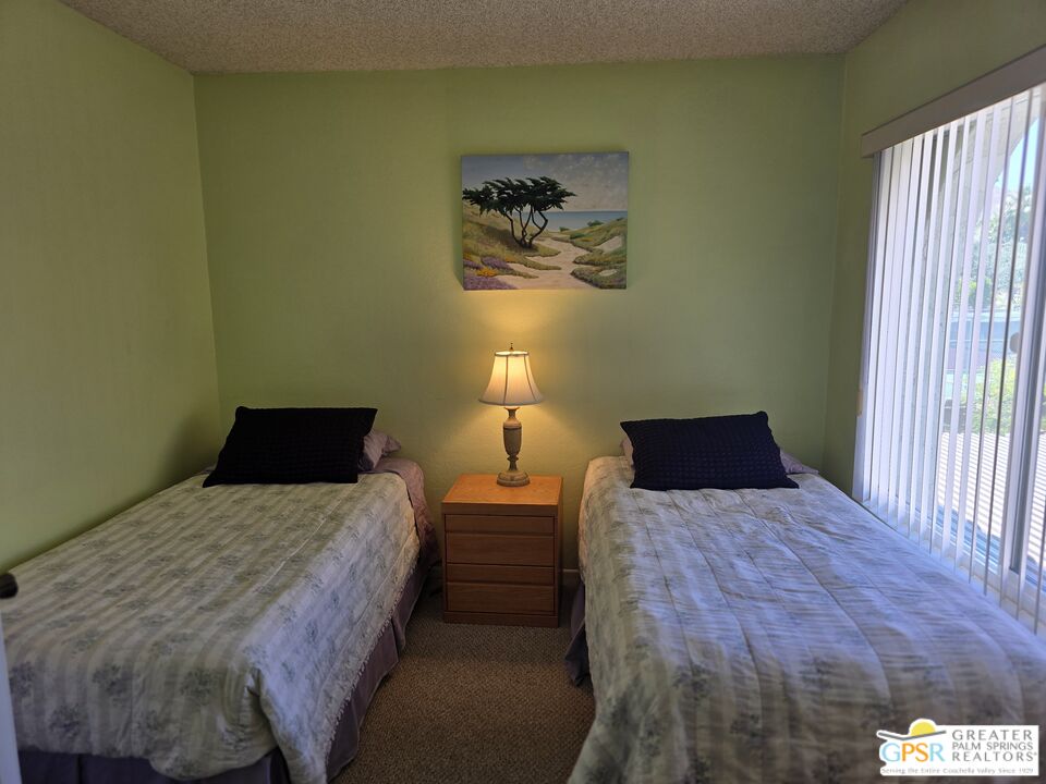 365 West Mariscal Road Palm Springs, CA 92262 - Photo 17 of 25 a bedroom with a bed and a lamp next to a window