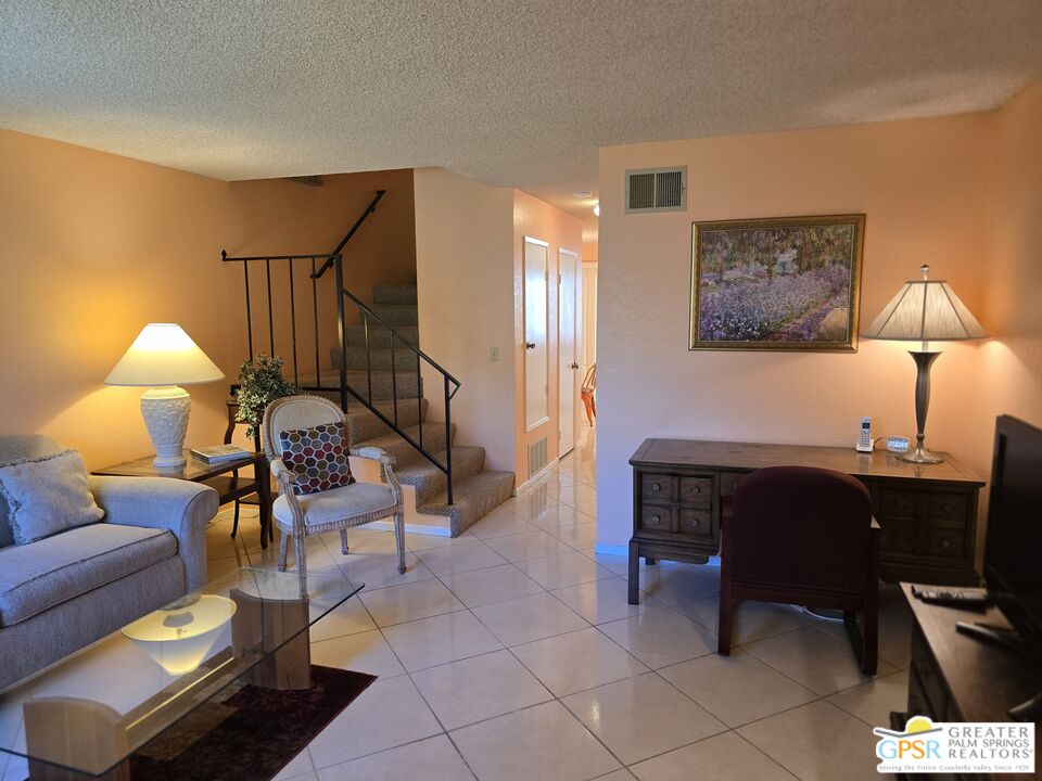 365 West Mariscal Road Palm Springs, CA 92262 - Photo 3 of 25 a living room with furniture a lamp and a dining table