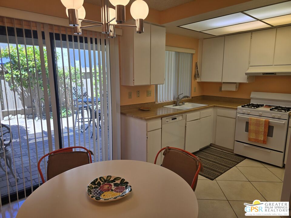 365 West Mariscal Road Palm Springs, CA 92262 - Photo 7 of 25 a kitchen with stainless steel appliances granite countertop a stove a sink and a microwave