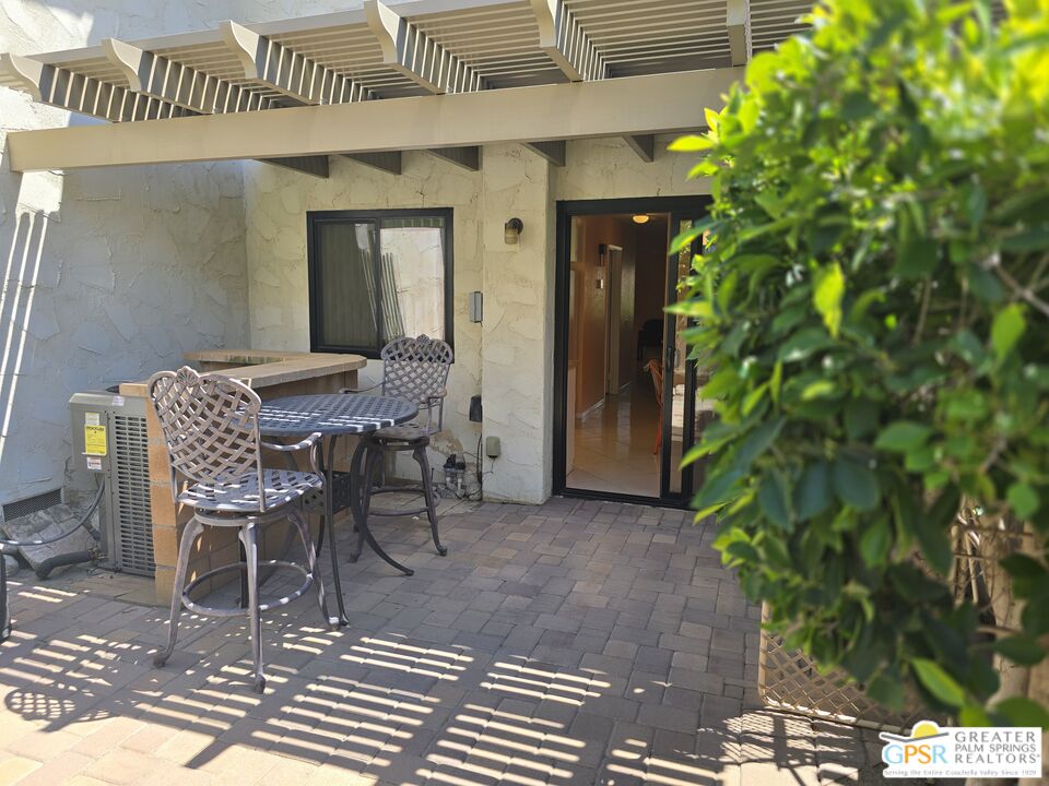 365 West Mariscal Road Palm Springs, CA 92262 - Photo 9 of 25 a view of a patio with table and chairs and potted plants
